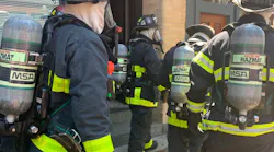 Boston firefighters respond to a Level 3 hazmat call at a five-story rooming house Friday.