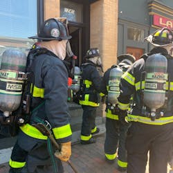 Boston firefighters respond to a Level 3 hazmat call at a five-story rooming house Friday.