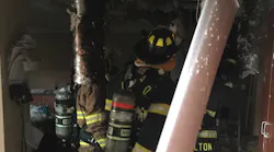 Daviess County, KY, firefighters walk through the fire damage caused by lightning hitting the fire station.
