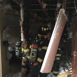 Daviess County, KY, firefighters walk through the fire damage caused by lightning hitting the fire station. Daviess County, KY, firefighters walk through the fire damage caused by lightning hitting the fire station.