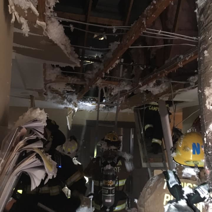 Daviess County, KY, firefighters deal with the damage to their station in the aftermath of a fire caused by a lightning strike Tuesday night.
