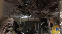 Daviess County, KY, firefighters deal with the damage to their station in the aftermath of a fire caused by a lightning strike Tuesday night.
