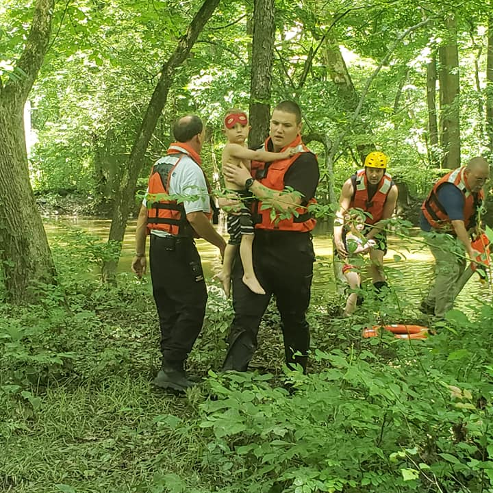 Greenville, PA, firefighters rescued four people&mdash; two adults and two young children&mdash; after their raft became entangled on a downed tree in the Shenango River on Tuesday.