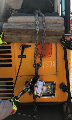 One option to displace the steering column on a Type D school bus is to use a chain hoist.