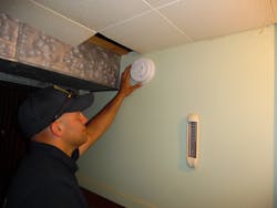 FF Nick Condidorio installing a smoke alarm during a campaign after a recent fire in the neighborhood. FF Nick Condidorio installing a smoke alarm during a campaign after a recent fire in the neighborhood.