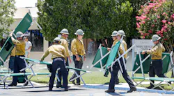 Firefighters place cots for patients that are being evacuated from Ridgecrest Regional Hospital after Ridgecrest, CA, was hit by a 6.4 earthquake on Thursday, July 4, 2019.