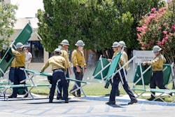 Firefighters place cots for patients that are being evacuated from Ridgecrest Regional Hospital after Ridgecrest, CA, was hit by a 6.4 earthquake on Thursday, July 4, 2019.