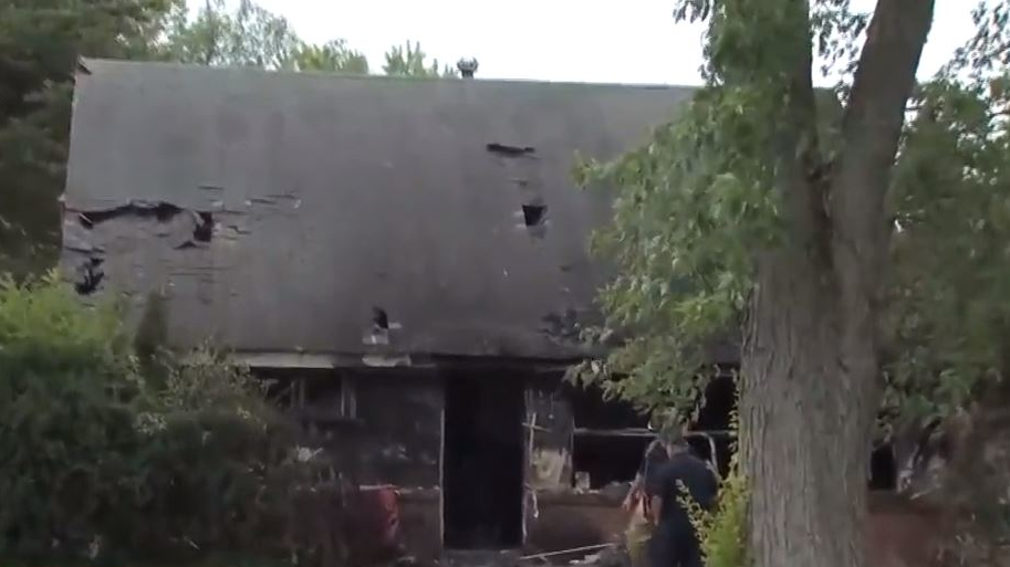 A Columbus, OH, firefighter suffered a back injury while battling a house fire Monday that also sent a resident to the hospital in critical condition with burns.