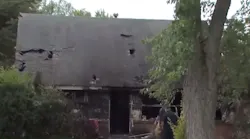 A Columbus, OH, firefighter suffered a back injury while battling a house fire Monday that also sent a resident to the hospital in critical condition with burns.