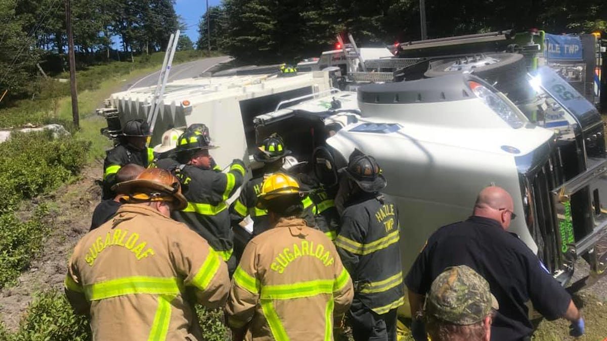Hazle Township, PA, firefighters rescued a driver Monday who was trapped inside an overturned recycling collection truck.