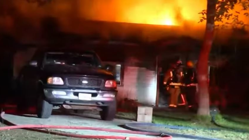 Firefighters faced a lack of nearby hydrants and bullets in a gun safe 'going off' as they battled a two-alarm house blaze early Friday.