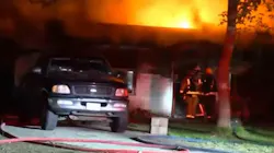 Firefighters faced a lack of nearby hydrants and bullets in a gun safe 'going off' as they battled a two-alarm house blaze early Friday.