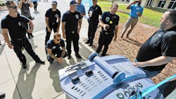 Jacksonville, FL, are shown how to shut off and disconnect the electrical system from the battery of an autonomous vehicle.