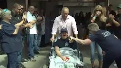 Tommy Spiotta, the 19-year-old son of a North Patchogue, NY, firefighter, receives cheers from his firehouse family after being released from the hospital Tuesday.