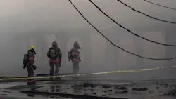 Firefighters battled a large grass fire that turned into a four-alarm blaze Monday.