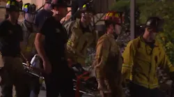 San Diego firefighters rescued a woman who became trapped in a narrow gap between walls after falling around 30 feet Wednesday night.