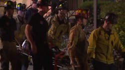 San Diego firefighters rescued a woman who became trapped in a narrow gap between walls after falling around 30 feet Wednesday night.