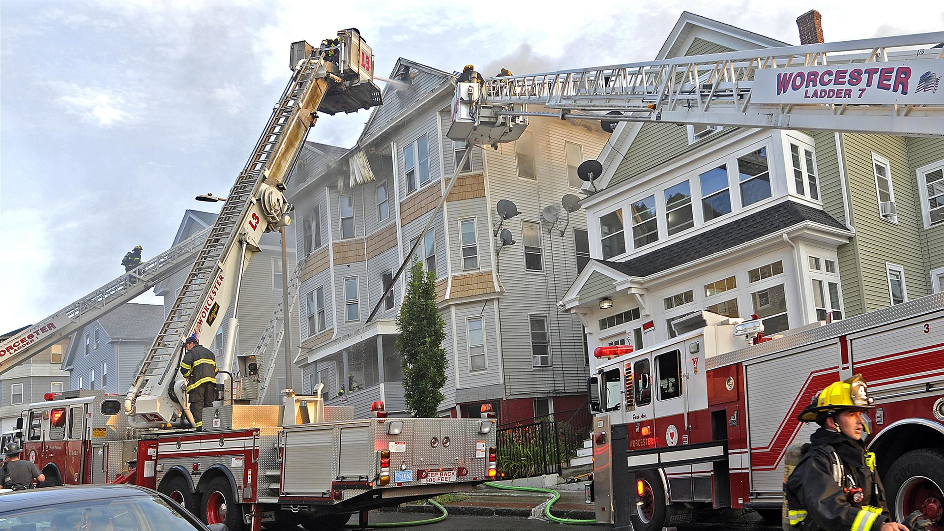 Worcester, MA, firefighters battle the four-alarm fire Thursday in the three-decker at 63 Harrison St.