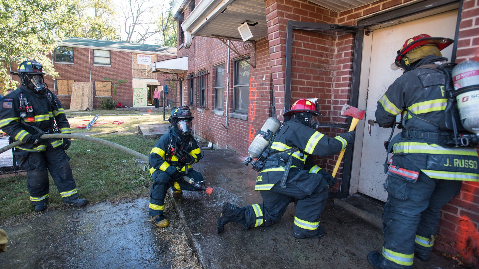 Firefighters prepare to enter a building for the Aggressive Fire Control, Flow Path, and VES Tactics HOT program.