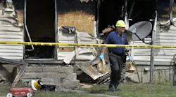 Erie Police Detective Lt. Chris Crawford carries possible evidence from a home at 1248 West 11th St. where five children died in an early morning fire on Sunday, Aug. 11, 2019.