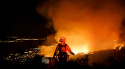 Firefighters watch for flare ups from the Holy Fire in Lake Elsinore, CA, on Aug. 10, 2018.