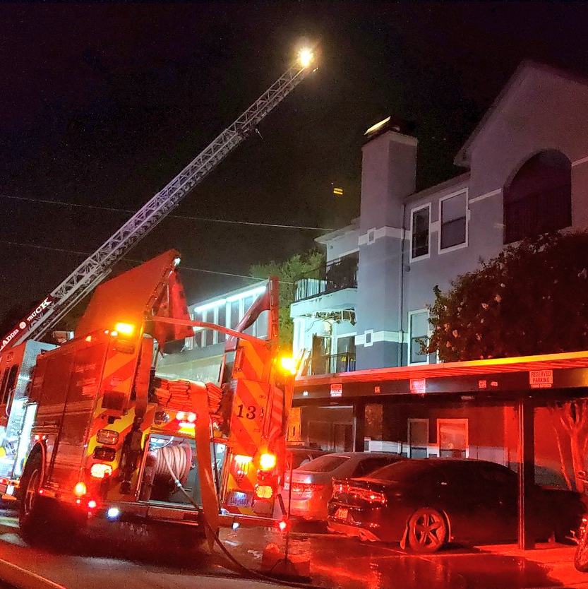 About 100 Dallas firefighters battled a four-alarm blaze that broke out when a utility pole collapsed into a three-story apartment complex Monday night.
