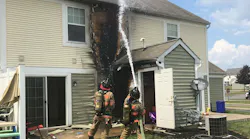 Dover Township, PA, firefighters douse flames in the attic area of a townhouse that caught fire Tuesday.