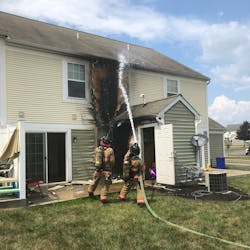 Dover Township, PA, firefighters douse flames in the attic area of a townhouse that caught fire Tuesday.