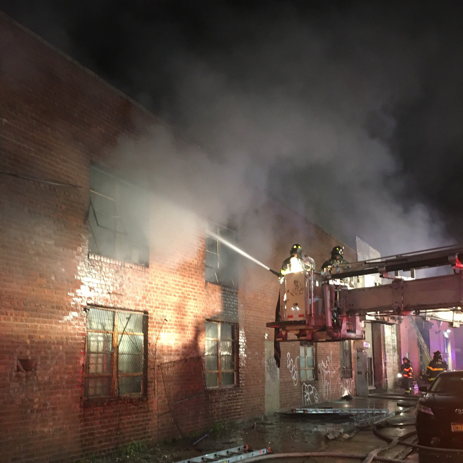 FDNY crews battle a four-alarm warehouse fire in Brooklyn early Thursday. Five firefighters were injured in the blaze.