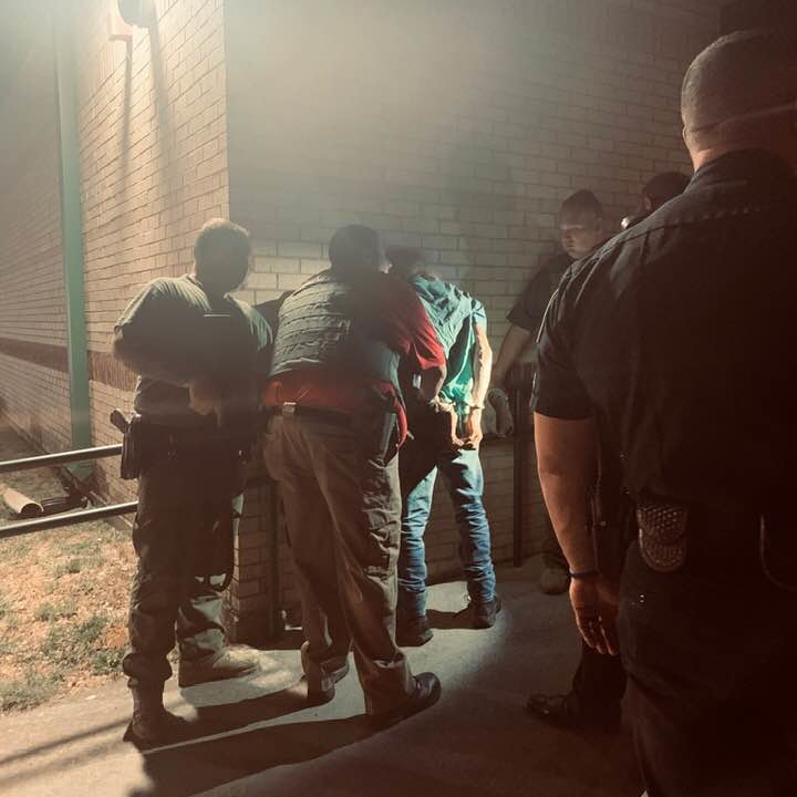 Paradise, TX, firefighters cut out an armed man who was trapped between the walls of a high school Wednesday.