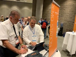 Blair Tyndall, right, VFIS Risk Control, demonstrates ResponderHelp.com at FRI. Blair Tyndall, right, VFIS Risk Control, demonstrates ResponderHelp.com at FRI.