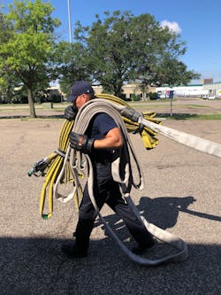 The nozzle firefighter shoulders the bundle and the first 50-foot stack of hose. Note the stack is flipped so if deploys off the top. The nozzle firefighter shoulders the bundle and the first 50-foot stack of hose. Note the stack is flipped so if deploys off the top.