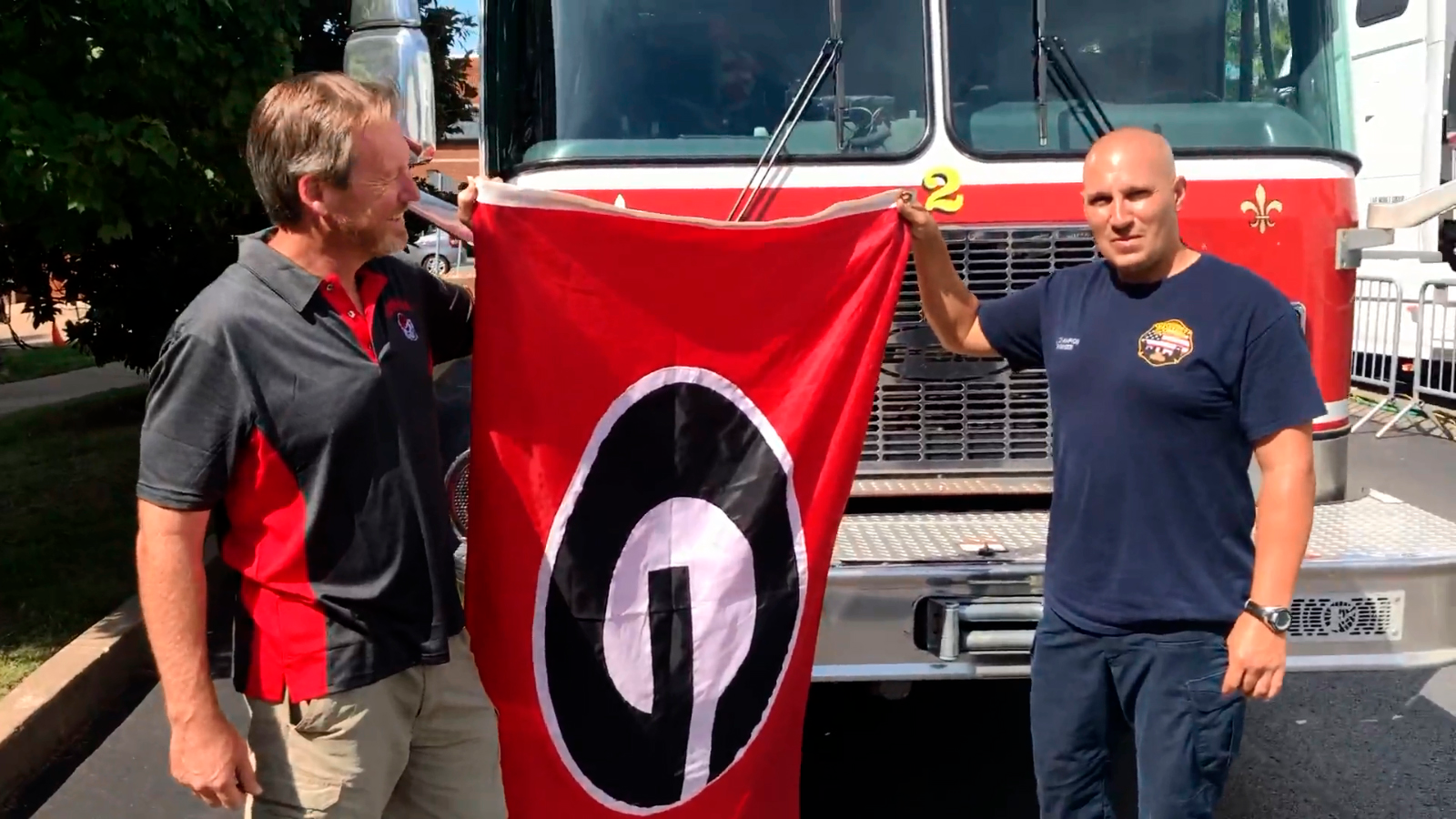 Joe Purcell, right, and Justin Champion exchange a 'Georgia G' flag.