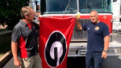 Joe Purcell, right, and Justin Champion exchange a 'Georgia G' flag. Joe Purcell, right, and Justin Champion exchange a 'Georgia G' flag.
