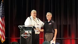 Bill Foster, left, vice president and founder of Spartan Motors, greets 2018 EVT of the Year Al Hasenfratz, right, as he prepares to give remarks at Spartan's Fire Truck Training Conference in Lansing, MI. Bill Foster, left, vice president and founder of Spartan Motors, greets 2018 EVT of the Year Al Hasenfratz, right, as he prepares to give remarks at Spartan's Fire Truck Training Conference in Lansing, MI.