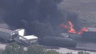 Firefighters tackled a fire that broke out following a train derailment in Dupo, IL, on Tuesday.