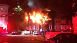 Two women were killed in a three-alarm fire Monday that also injured an Everett, MA, firefighter.