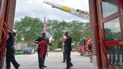 Monroe, MI, Fire Chief Rob Wright (left) and Mayor Robert E. Clark participate in the dedication ceremony of the city&apos;s new central fire station Monday.