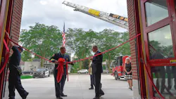 Monroe, MI, Fire Chief Rob Wright (left) and Mayor Robert E. Clark participate in the dedication ceremony of the city's new central fire station Monday.