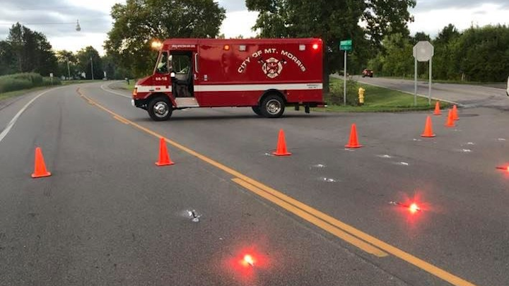 A Mount Morris fire apparatus sits near a Genesee Township intersection Wednesday. The apparatus was helping to block off access to the scene of a fatal two-vehicle crash.