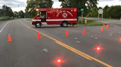 A Mount Morris fire apparatus sits near a Genesee Township intersection Wednesday. The apparatus was helping to block off access to the scene of a fatal two-vehicle crash.