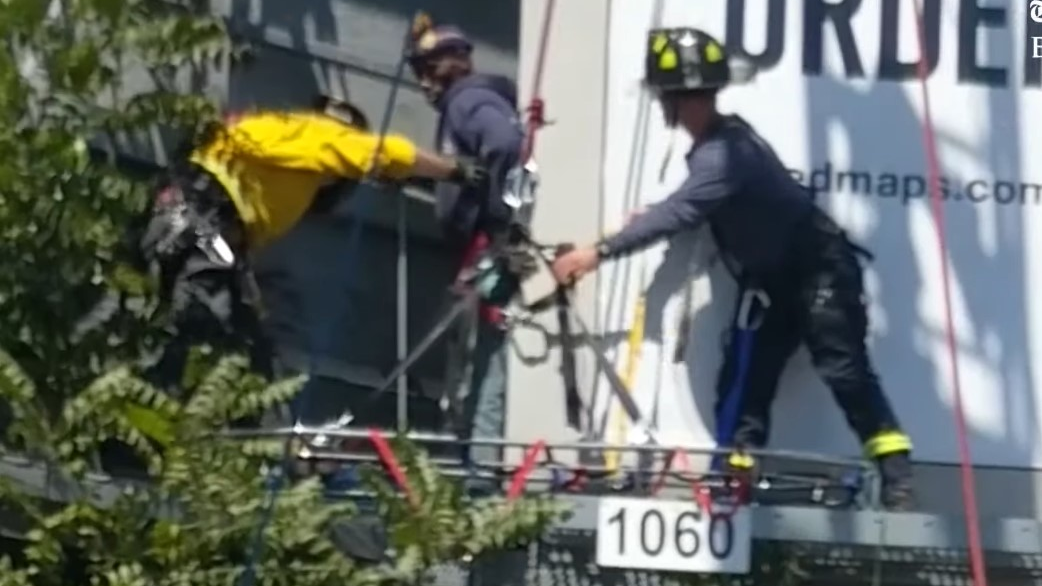 Menlo Park, CA, firefighters rescued a man who became trapped on a billboard after scaling it Tuesday.