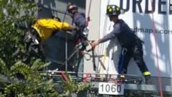 Menlo Park, CA, firefighters rescued a man who became trapped on a billboard after scaling it Tuesday.