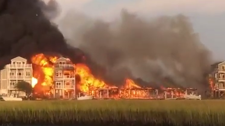 Surf City, NC, firefighters battled a massive blaze that destroyed or damaged at least seven homes Sunday.