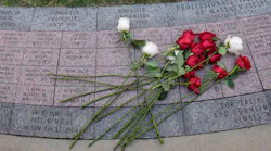Roses from Firefighter Christopher Roy's family lay on a stone bearing his name at the Massachusetts Fallen Firefighters Memorial in Boston on Wednesday.