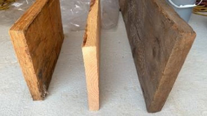 This photo shows the differences between an LVL (left), new growth sawn lumber (center), and old-growth sawn lumber (right).