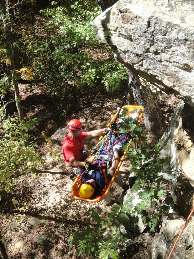 Firefighter participating in Advanced Wilderness Rope Rescue Course attends to patient. Photos by Russell McCullar