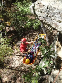 Firefighter participating in Advanced Wilderness Rope Rescue Course attends to patient. Photos by Russell McCullar Firefighter participating in Advanced Wilderness Rope Rescue Course attends to patient. Photos by Russell McCullar