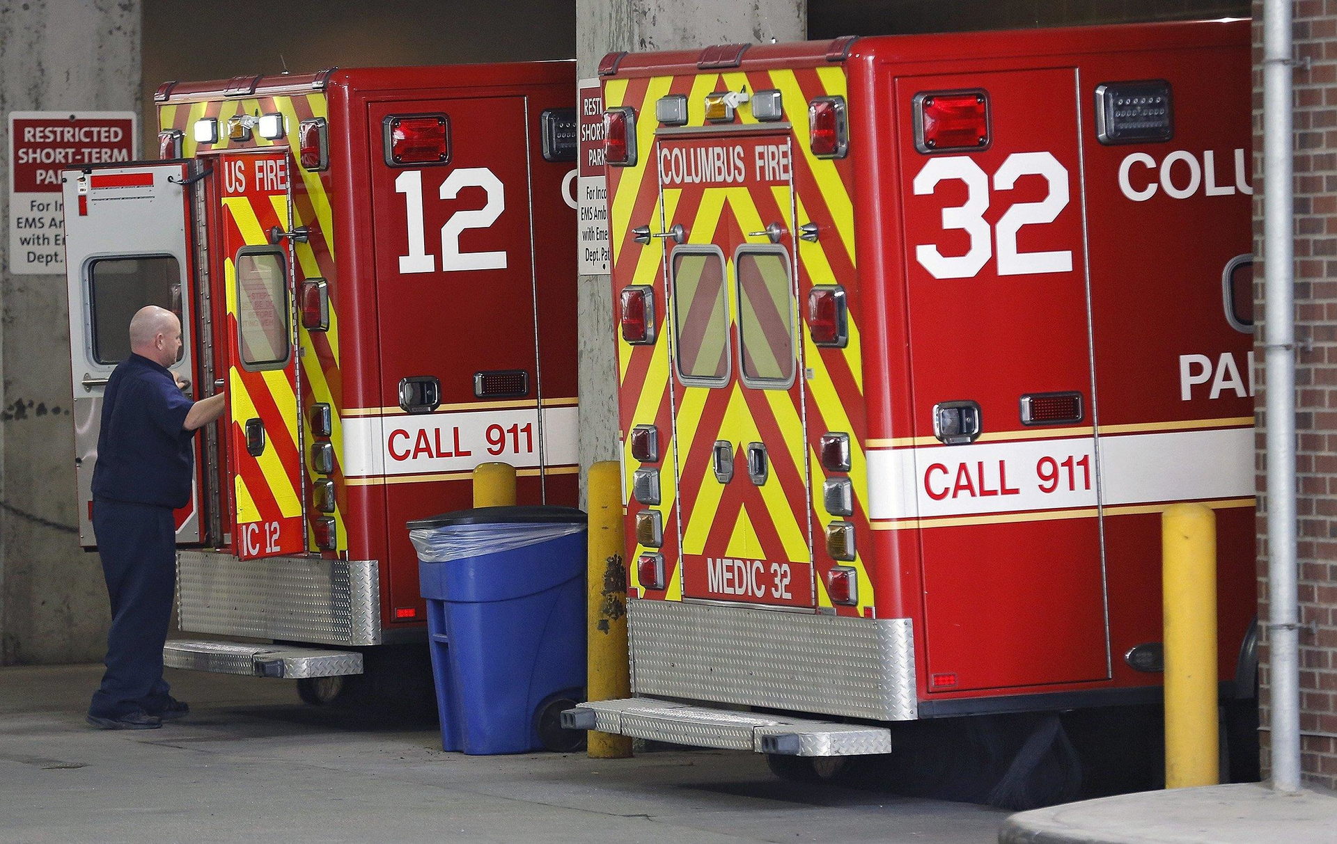 A Columbus Division of Fire paramedic gets ready to unload an ambulance at the emergency entrance at OhioHealth Grant Medical Hospital Downtown.
