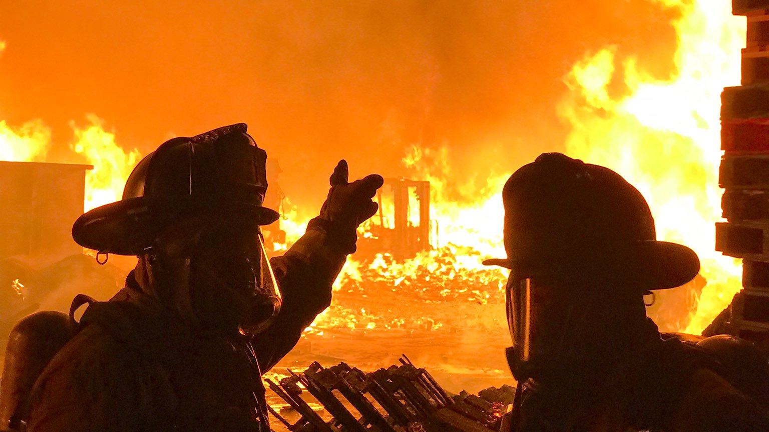 Atlanta firefighters battle a blaze that broke out following an explosion at a pallet warehouse early Friday.